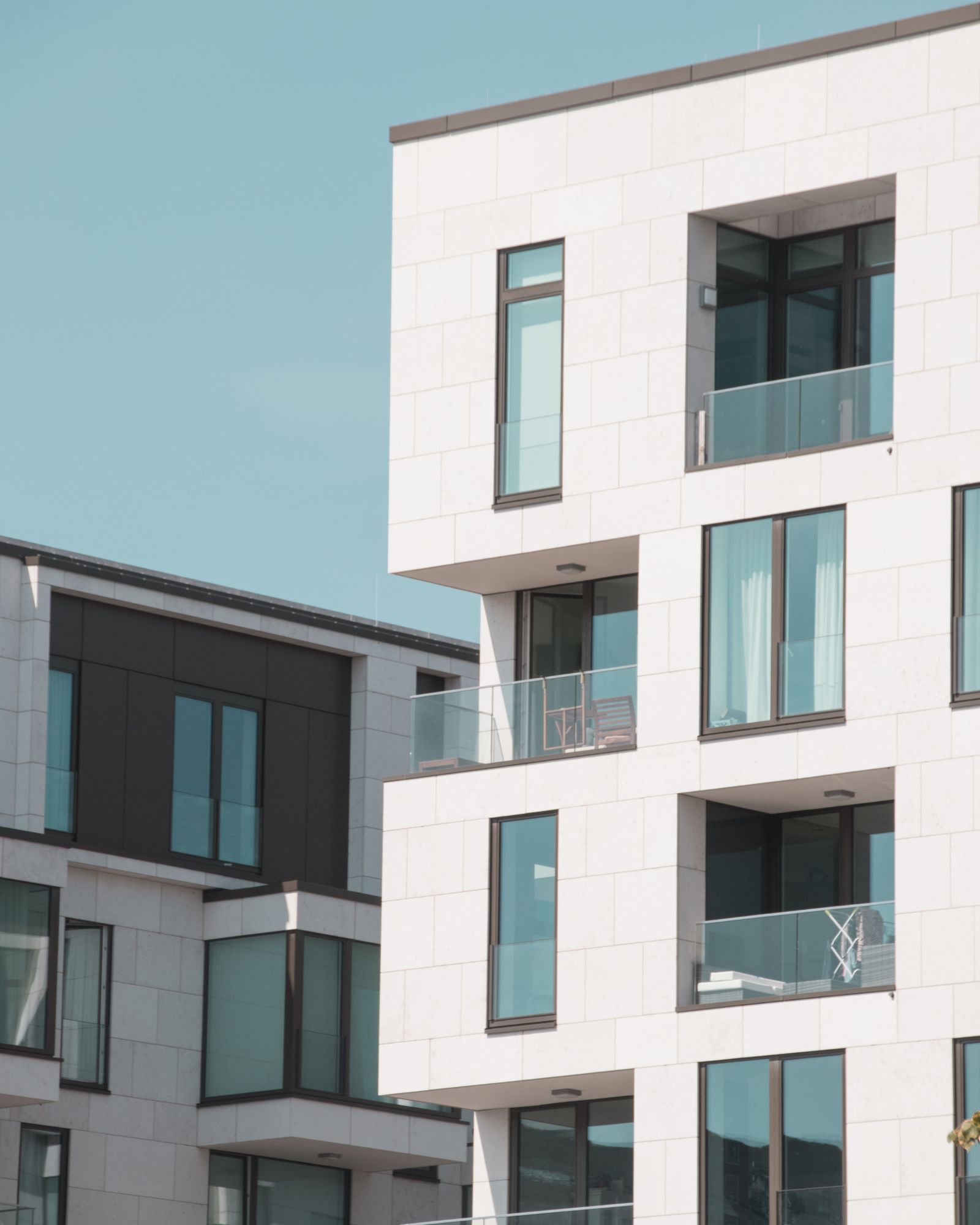 Contemporary apartment building exterior with glass balconies